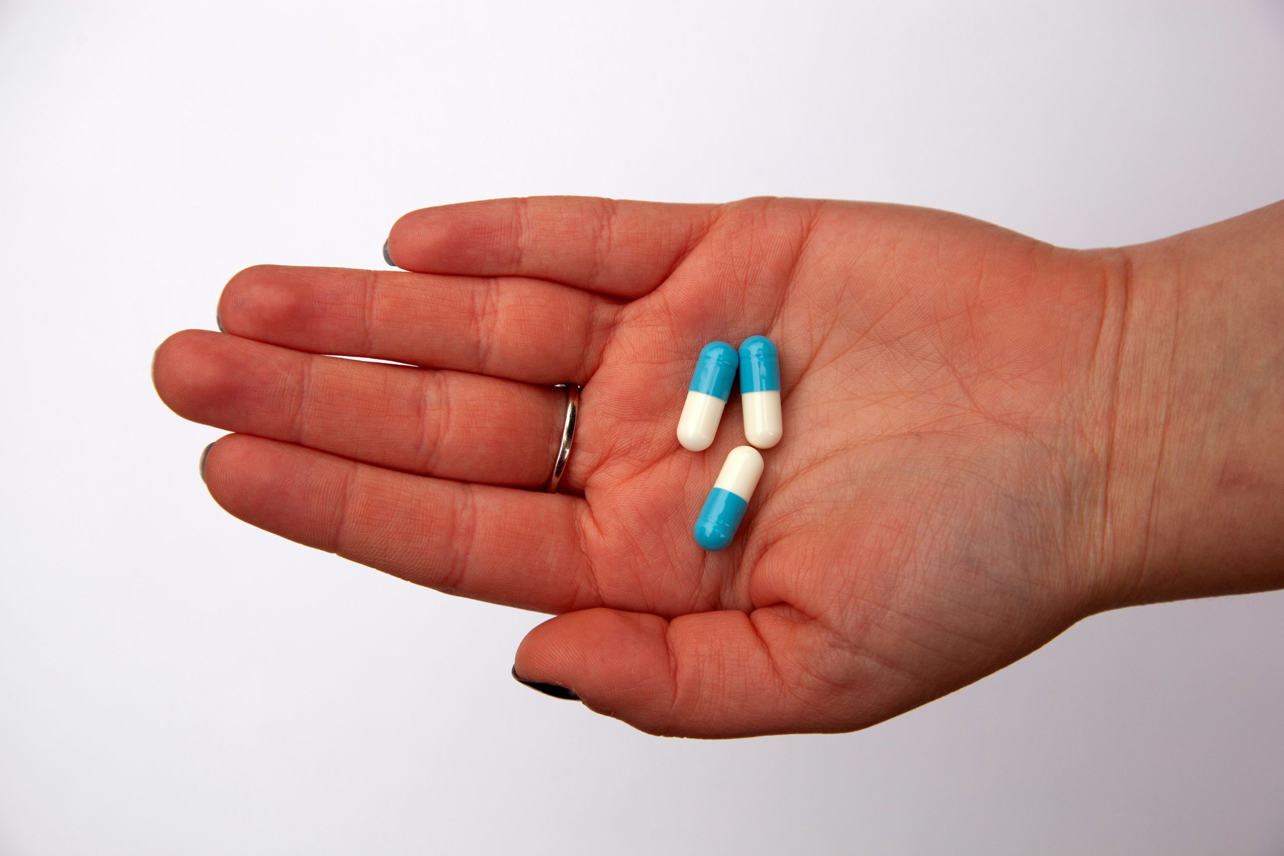 Image of antibiotics in hand of person.